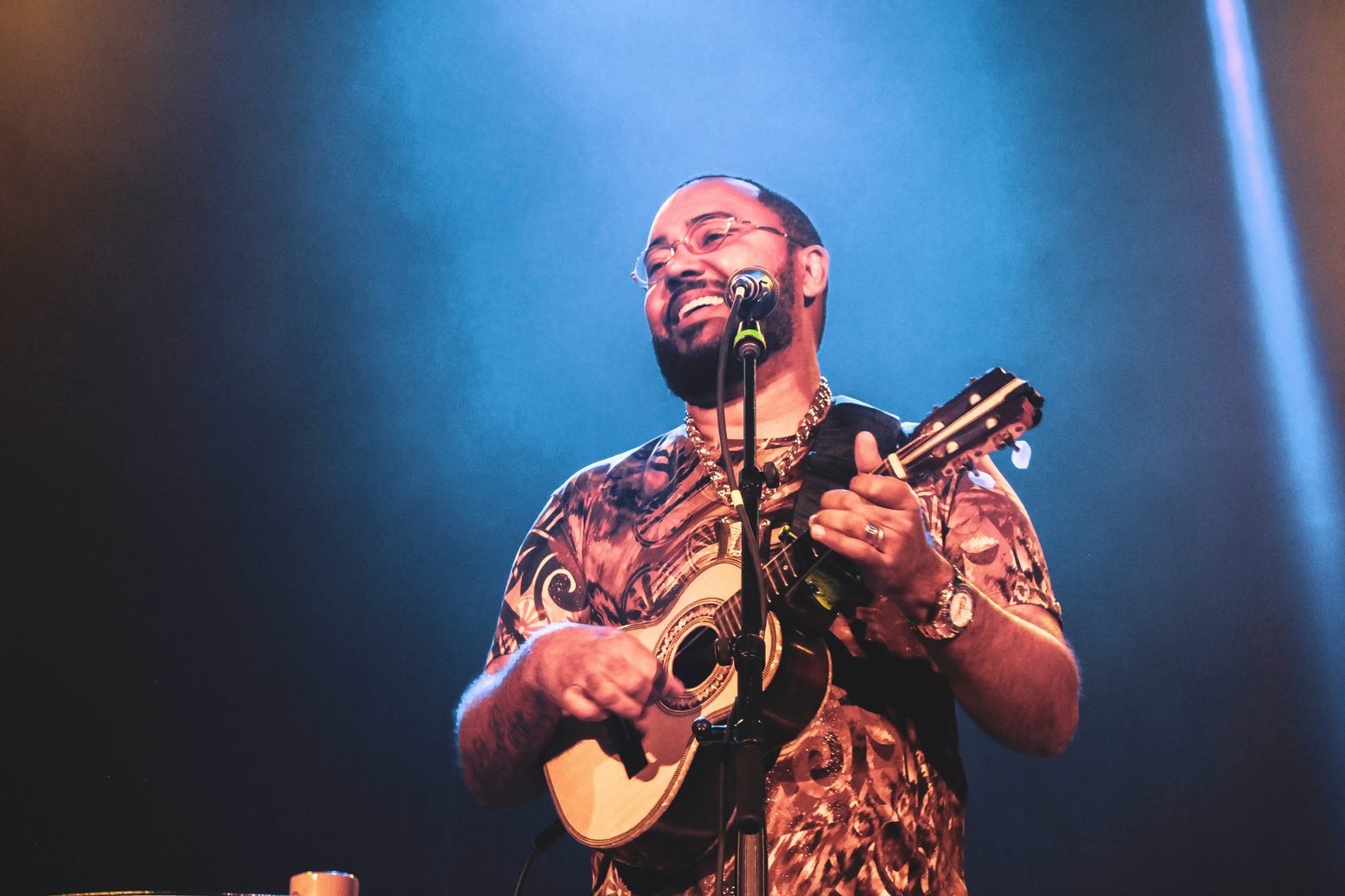Performer on stage under blue light, filmed by Crois Media